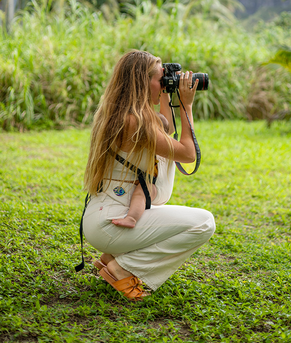 woman taking photo with baby