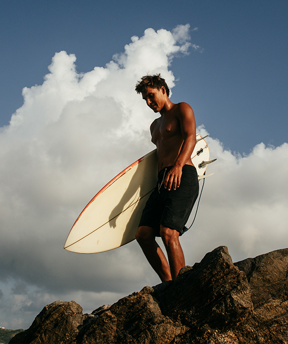 Surfer on Rocks