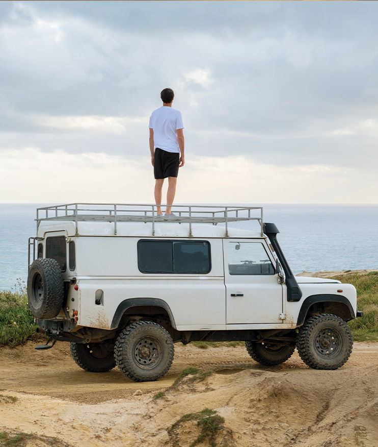 http://MAN%20STANDING%20ON%20TRUCK%20WATCHING%20OCEAN